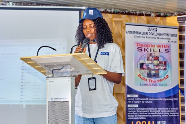 An ENDIP participant speaking at a podium beside the 
