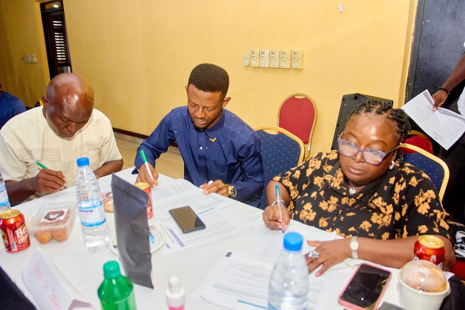 Participants completing forms during a programme workshop